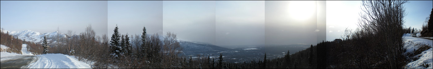 This stitched-together 180-degree view shows the ash cloud in the middle, with clear and blue skies to the south (left) and north. Photo copyright 2009 by Leon Unruh.